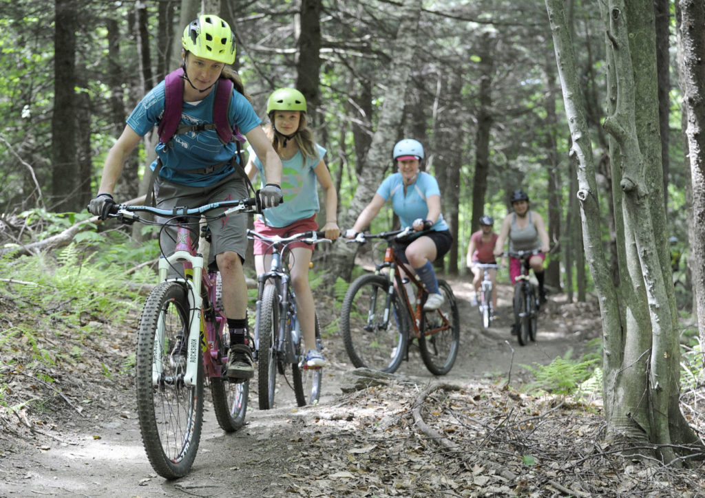 Jeb Wallace-Brodeur / Staff Photo
Former World Cup downhill bike racer Ali Zimmer of Lincoln, left, leads a womens group ride during National Trails Day festivities at the Blueberry Lake trails in Warren on Sunday. The Mad River Riders mountain bike group received an award from the U.S. Forest Service for their trail building efforts and ground was broken on a new trail being constucted this summer.